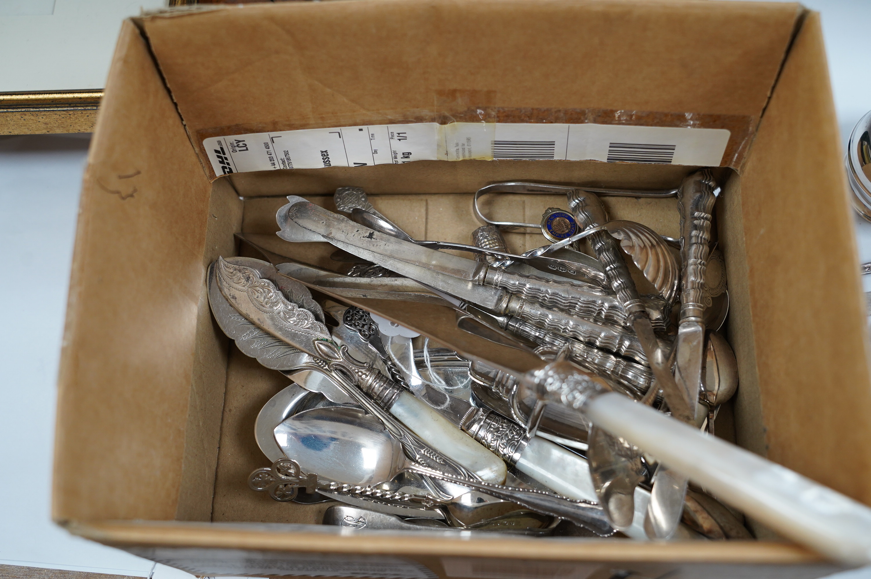 A small group of assorted teaspoons, condiment spoons, small servers, etc. including a Millennium seal top spoon by A. E. Jones Ltd and a Victorian shell bowl ladle by Jehoiada Alsop Rhodes and a silver thimble together